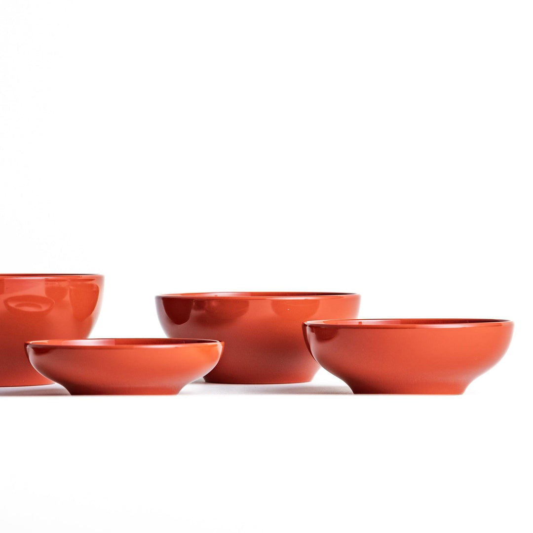 Set of five nested lacquer bowls used in Japanese oryoki meals representing minimalism mindfulness in black or red.