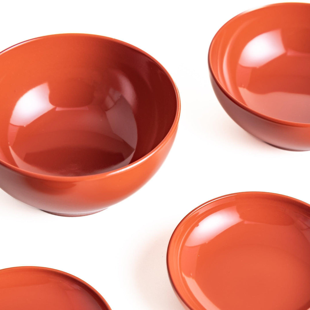 Set of five nested lacquer bowls used in Japanese oryoki meals representing minimalism mindfulness in black or red.