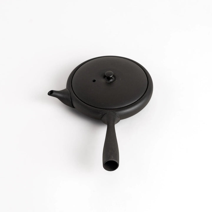 Sleek black teapot with flat body and side handle offering minimalist design for elegant Japanese tea.