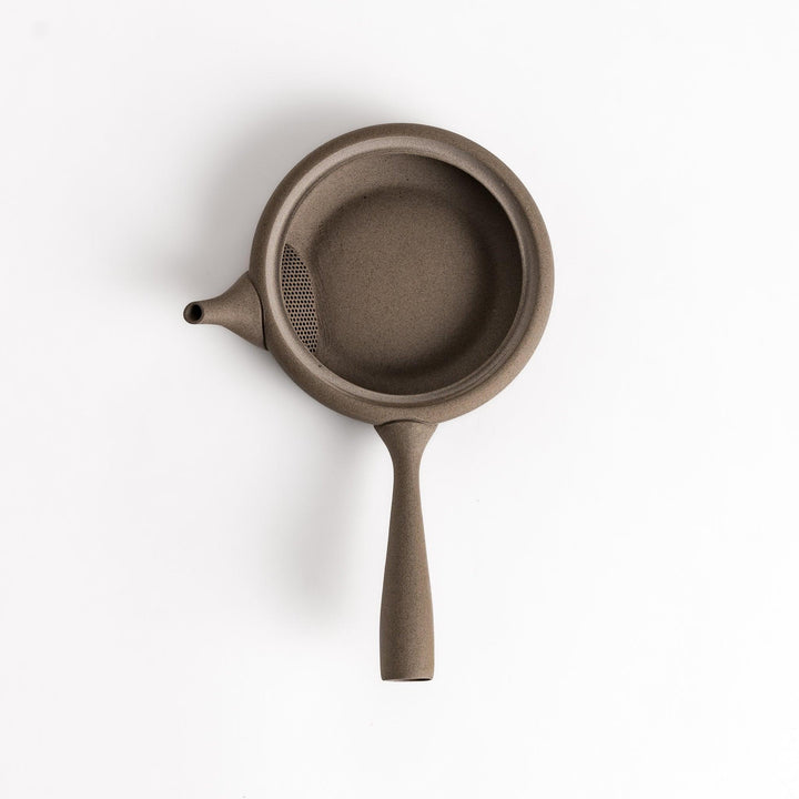 Sleek gray teapot with flat body and side handle offering minimalist aesthetic for modern tea setting.