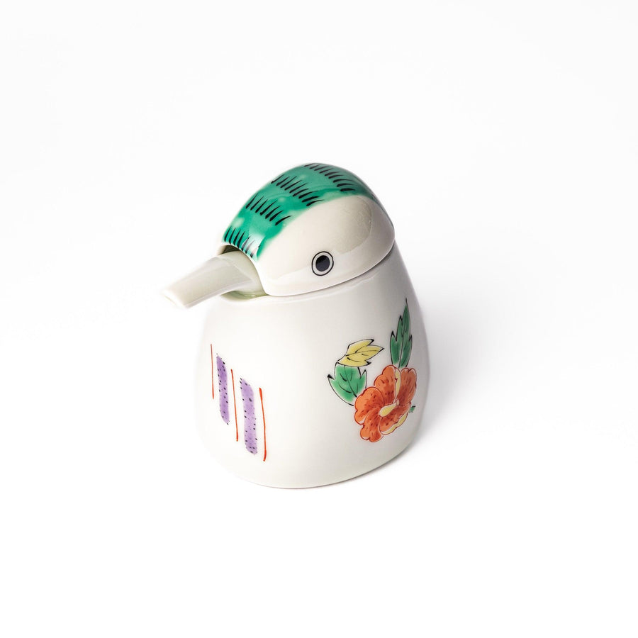 A bird-shaped soy sauce dispenser featuring a traditional floral design in red, green, and orange.