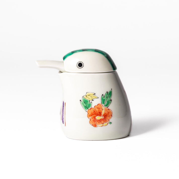 A bird-shaped soy sauce dispenser featuring a traditional floral design in red, green, and orange.