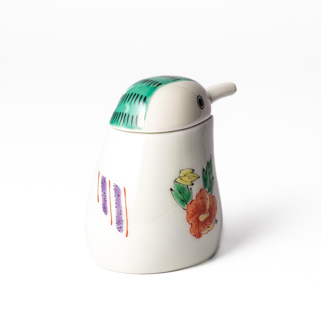 A bird-shaped soy sauce dispenser featuring a traditional floral design in red, green, and orange.