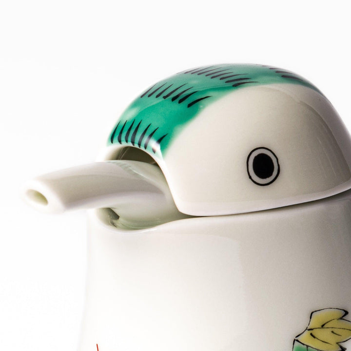 A bird-shaped soy sauce dispenser featuring a traditional floral design in red, green, and orange.