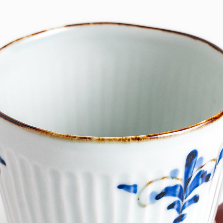 Floral Leaves mug with red handle, detailed blue floral motifs, and gold trim for an elegant tea experience.