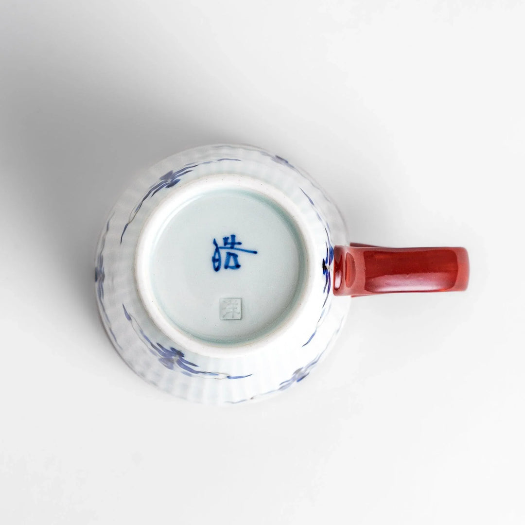 Floral Leaves mug with red handle, detailed blue floral motifs, and gold trim for an elegant tea experience.