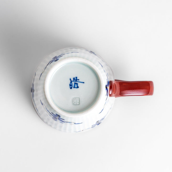 Floral Leaves mug with red handle, detailed blue floral motifs, and gold trim for an elegant tea experience.