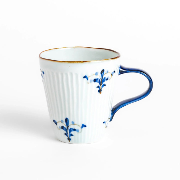 Floral Leaves mug with blue handle, featuring blue floral motifs, ribbed body, and gold trim for a refined look.