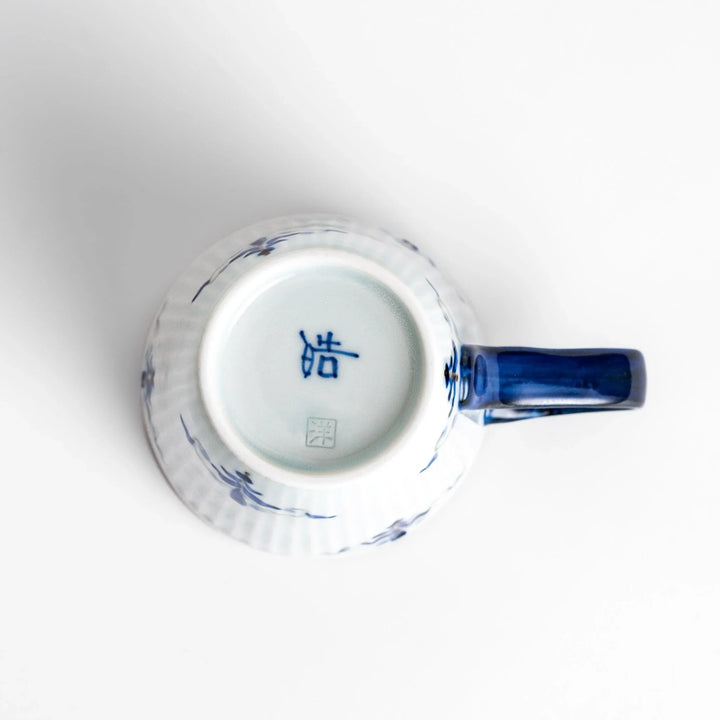Floral Leaves mug with blue handle, featuring blue floral motifs, ribbed body, and gold trim for a refined look.