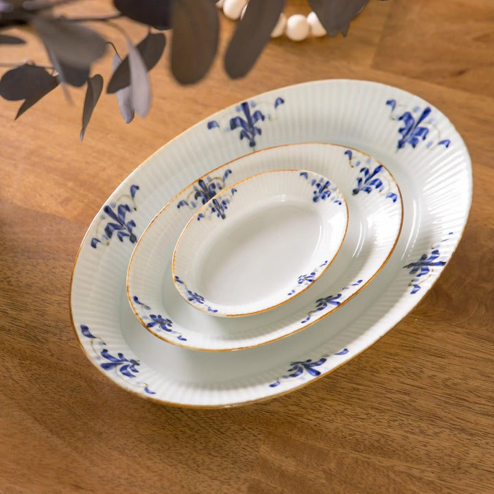 Three piece oval plate set with ridged design and blue floral motifs including large medium and small plates.