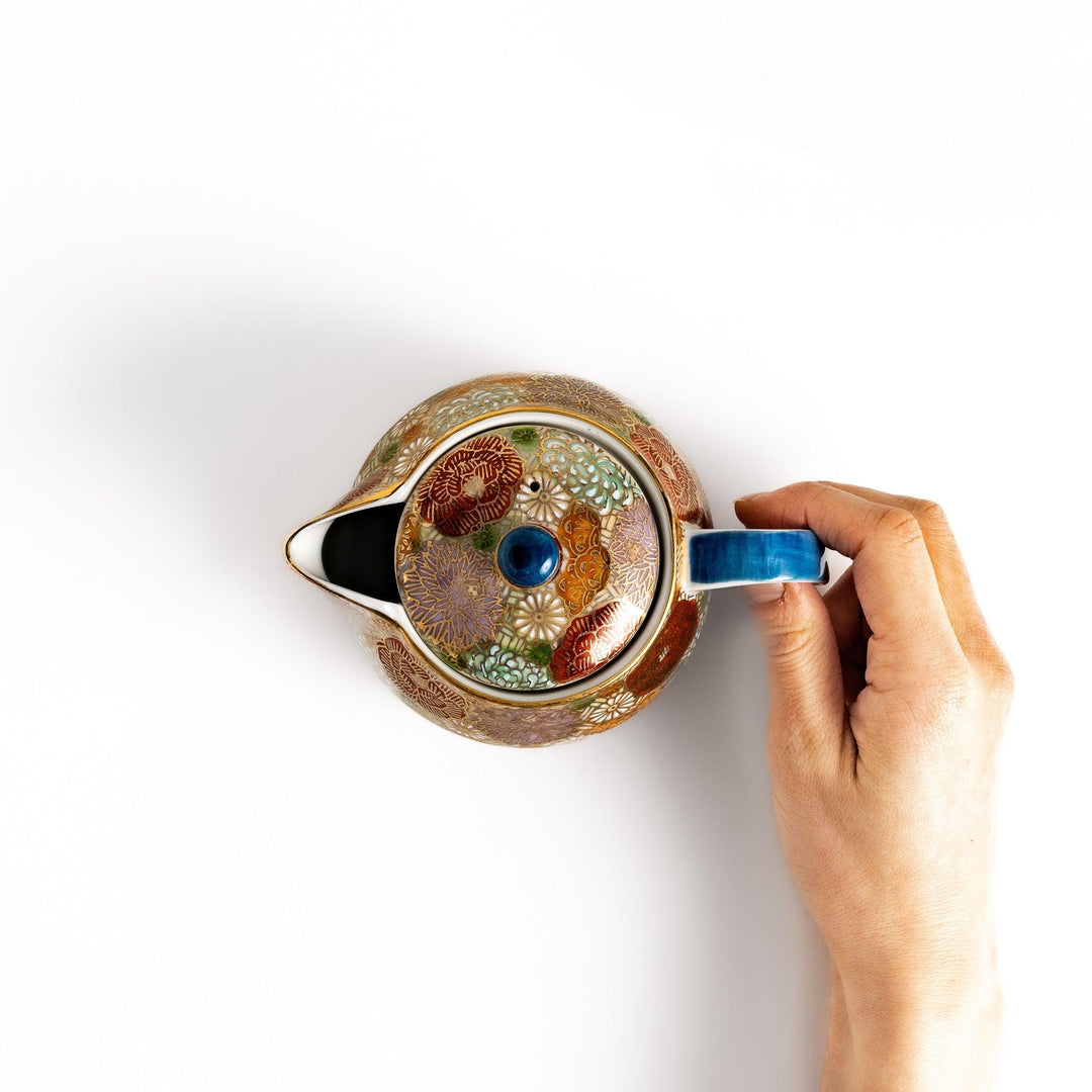 Ceramic teapot with floral pattern in gold and pastels classic design ideal for brewing Japanese tea.