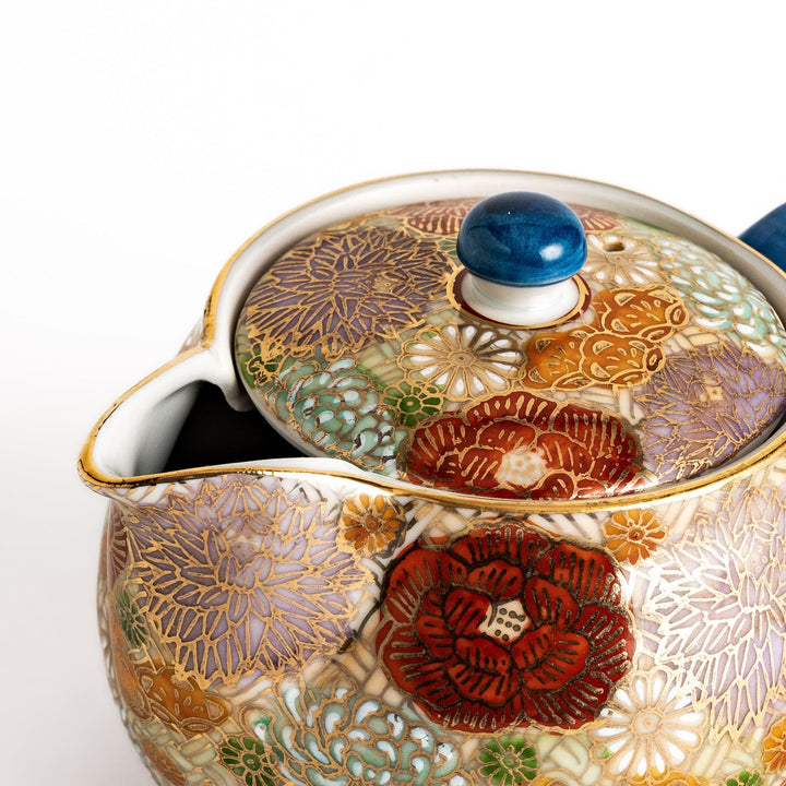 Ceramic teapot with floral pattern in gold and pastels classic design ideal for brewing Japanese tea.