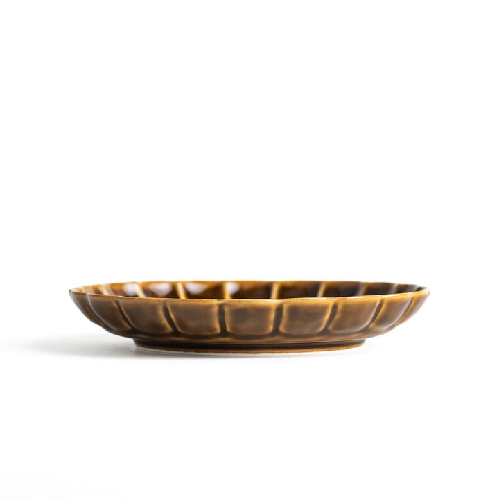 Round, dark brown or olive colored dessert plate with a scalloped edge, featuring a glossy finish.