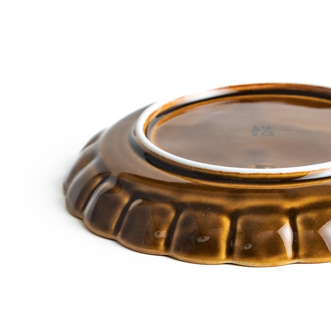 Round, dark brown or olive colored dessert plate with a scalloped edge, featuring a glossy finish.