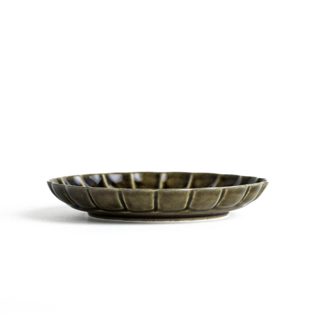 Round, dark brown or olive colored dessert plate with a scalloped edge, featuring a glossy finish.