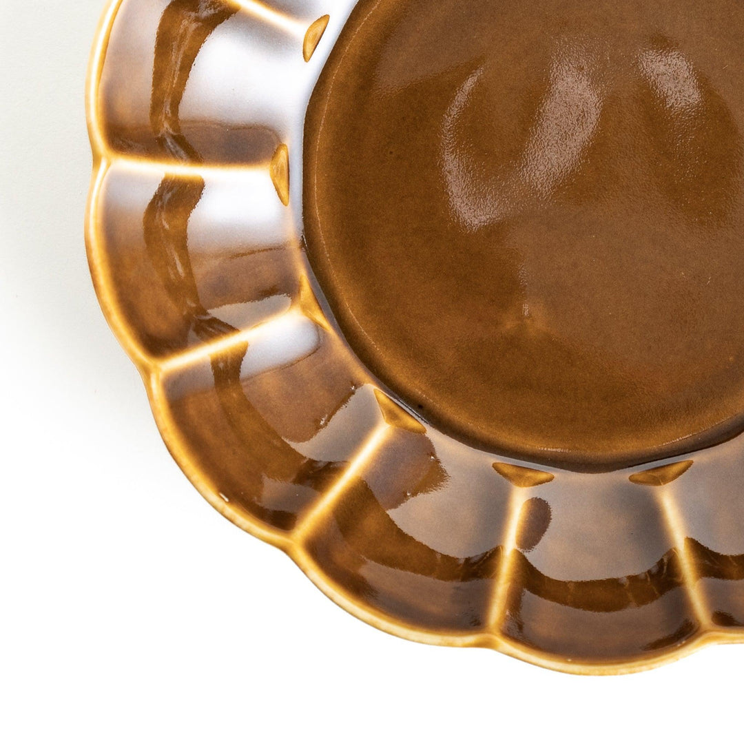 Cereal bowl with scalloped edges and a glossy dark brown or olive finish.