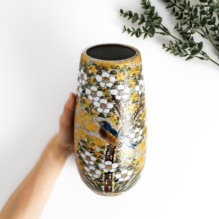 Flower vase with hand painted blooms and perched bird in warm gold and green tones for refined display.
