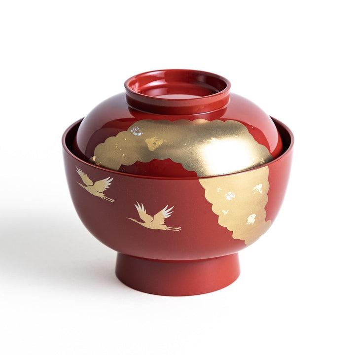 A lacquered soup bowl with a gold-painted cloud and crane motif. Available in red or black.