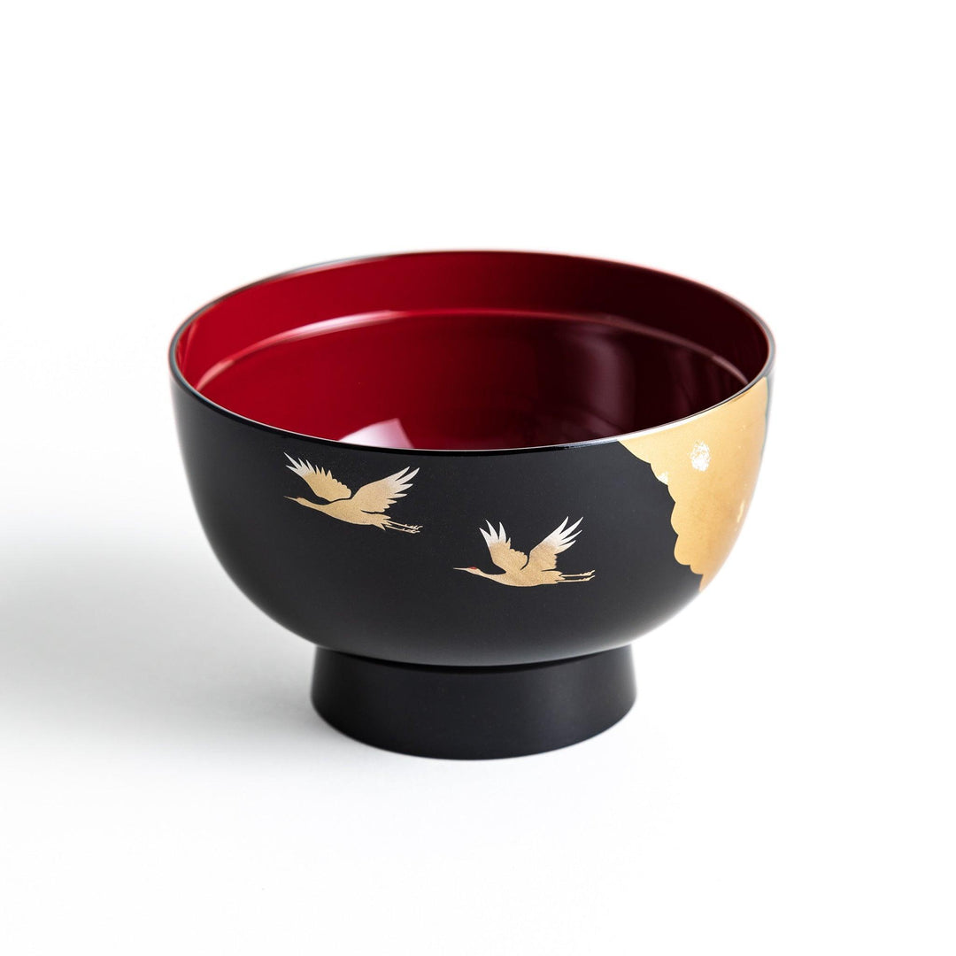 A lacquered soup bowl with a gold-painted cloud and crane motif. Available in red or black.