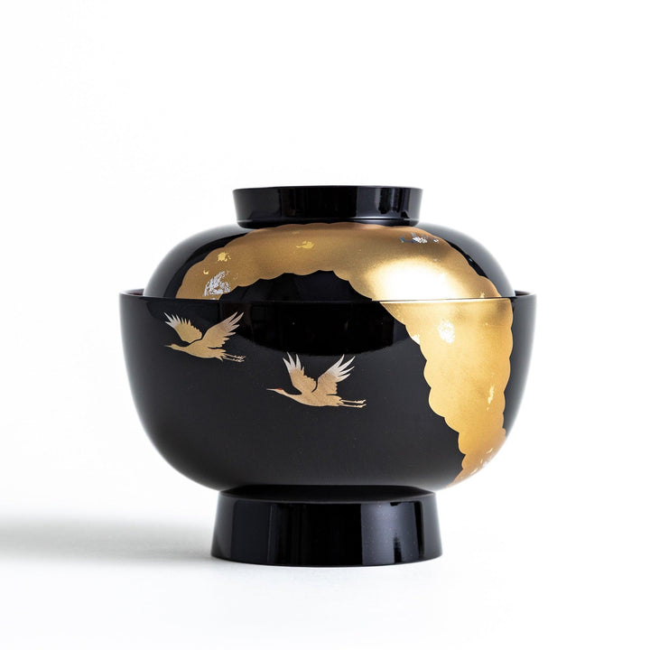 A lacquered soup bowl with a gold-painted cloud and crane motif. Available in red or black.