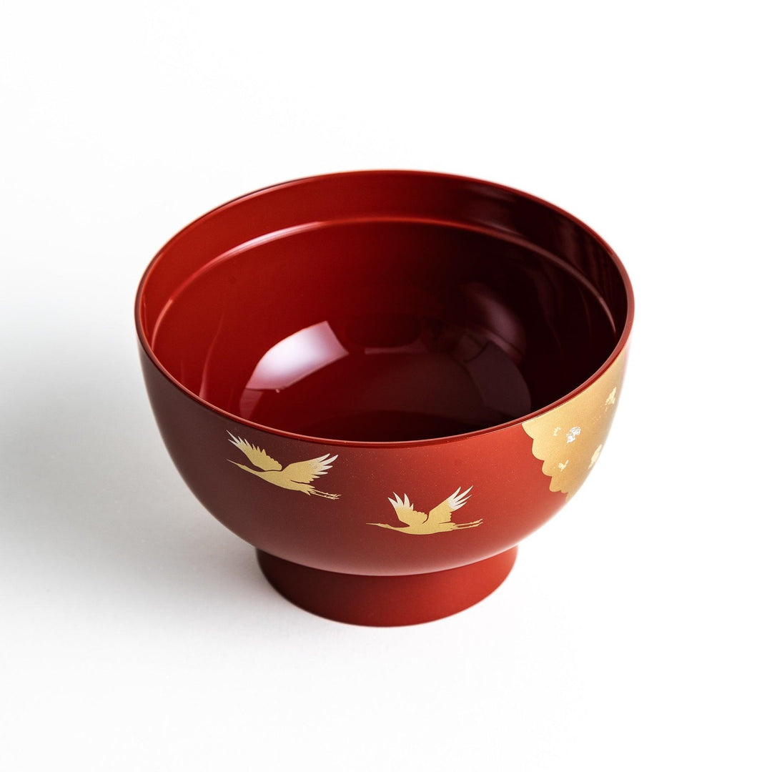 A lacquered soup bowl with a gold-painted cloud and crane motif. Available in red or black.