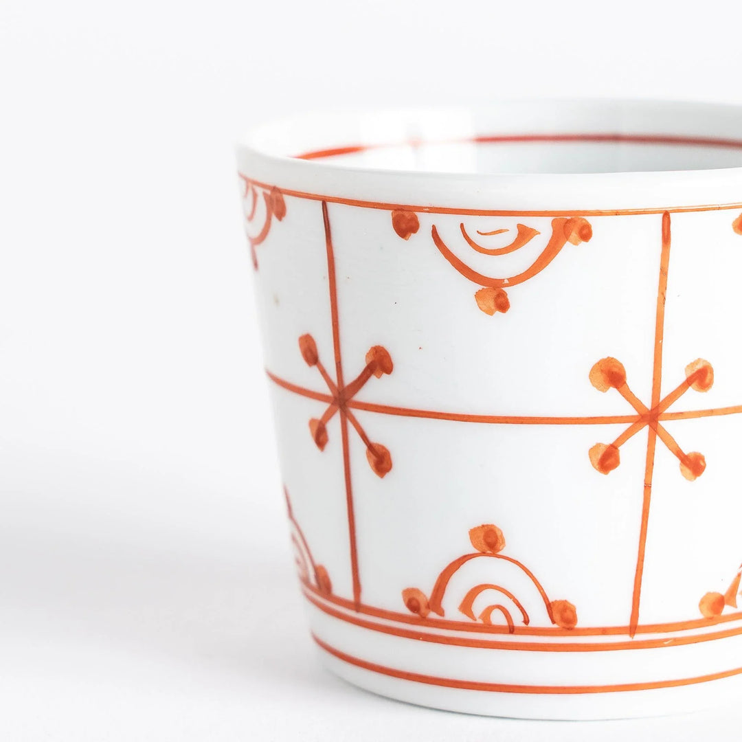 A small white condiment bowl with a delicate blue chrysanthemum and lattice pattern on the exterior.