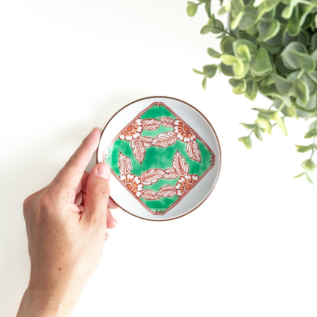 Round plate with green Mt. Fuji pattern and orange floral design.