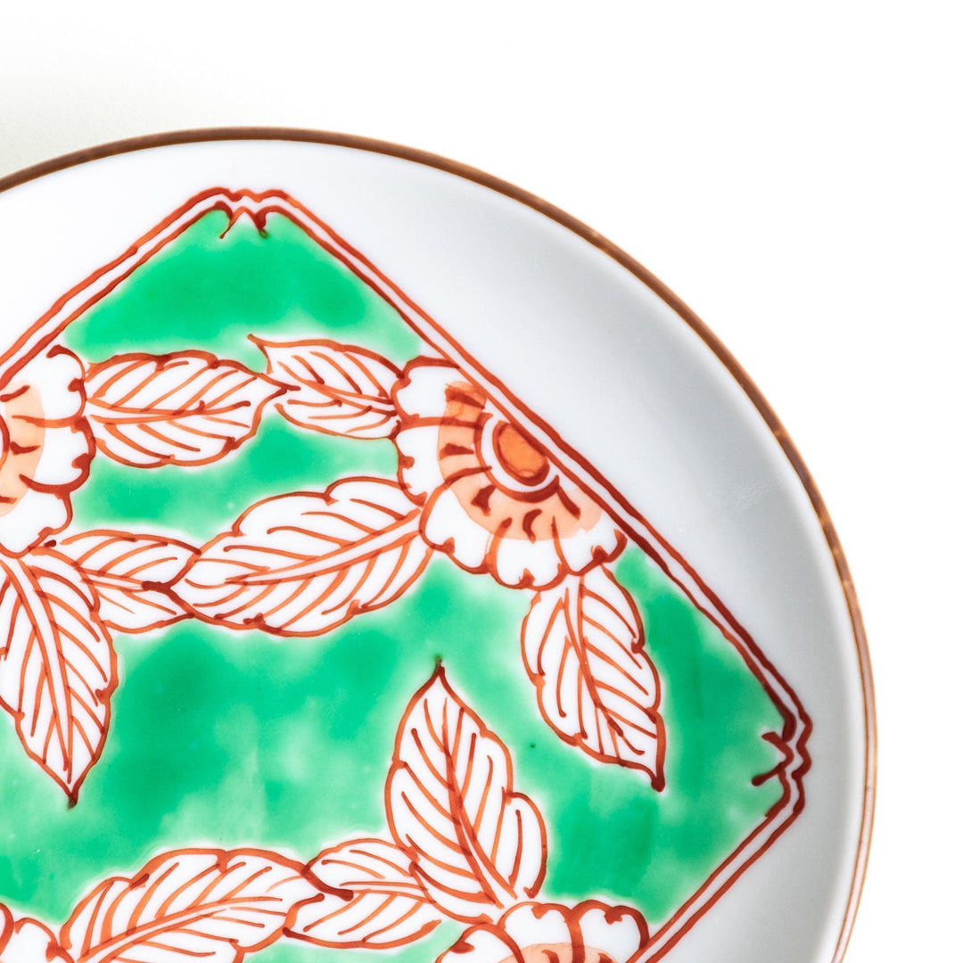 Round plate with green Mt. Fuji pattern and orange floral design.