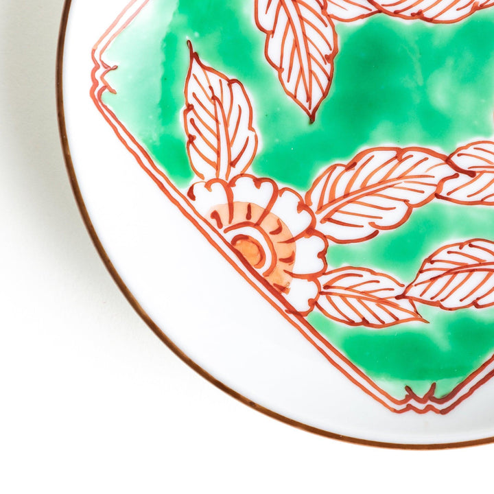 Round plate with green Mt. Fuji pattern and orange floral design.
