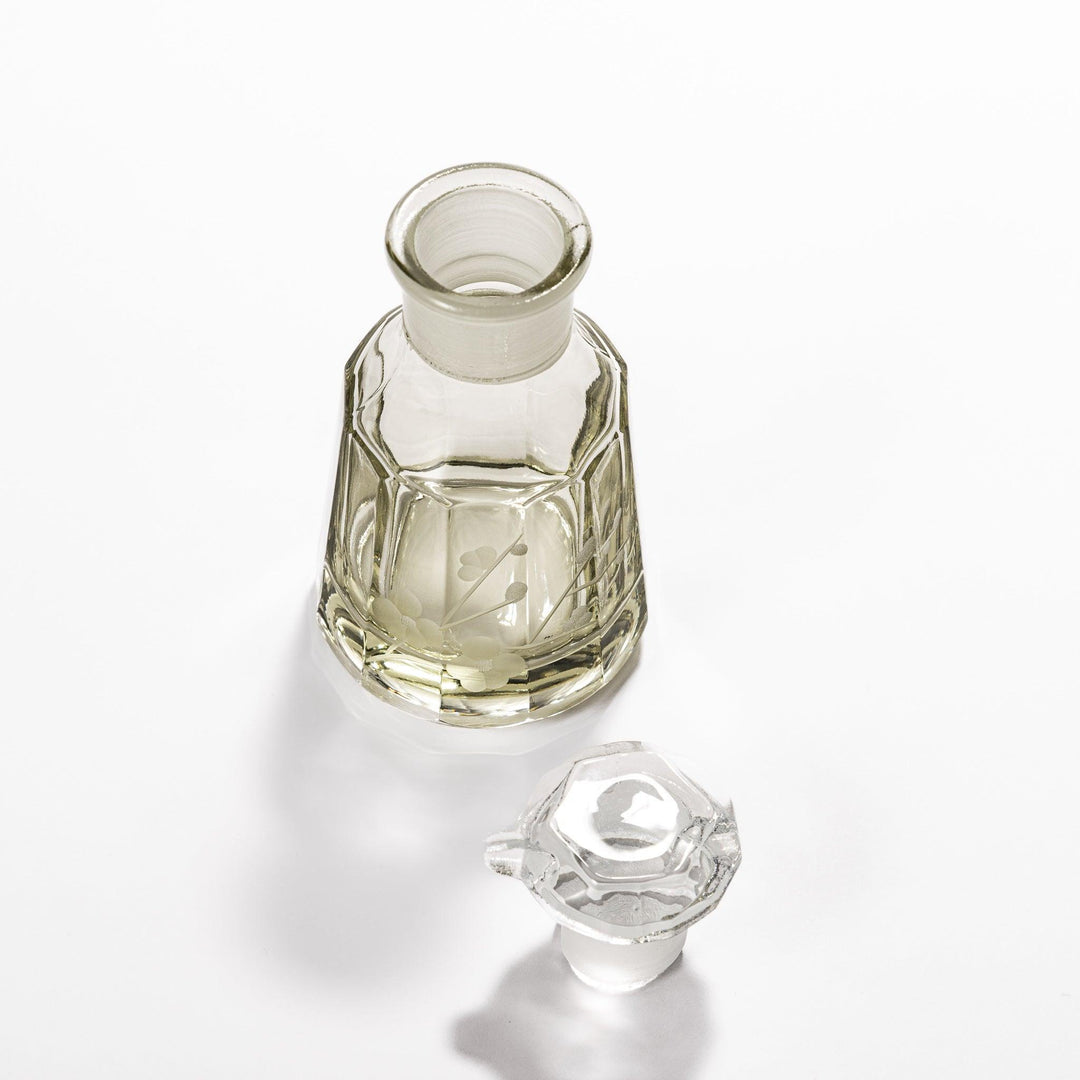 Soy sauce dispenser with frosted plum blossom design and smooth pour spout, featuring a geometric base.