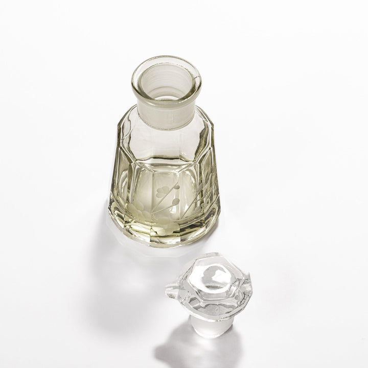 Soy sauce dispenser with frosted plum blossom design and smooth pour spout, featuring a geometric base.