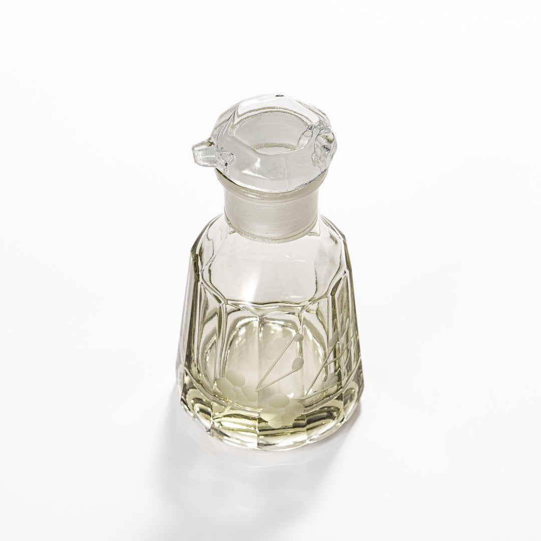 Soy sauce dispenser with frosted plum blossom design and smooth pour spout, featuring a geometric base.