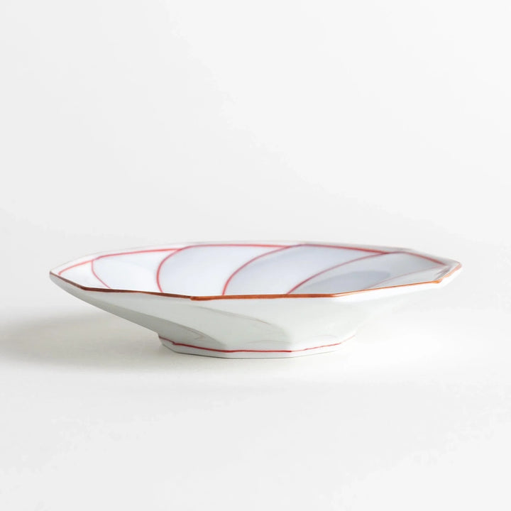 Octagonal dessert plate with a petal design and bowl shape, outlined in blue and red with a brown rim.