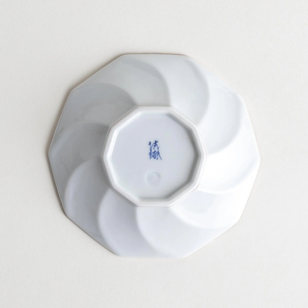 Octagonal dessert plate with a petal design and bowl shape, outlined in blue and red with a brown rim.