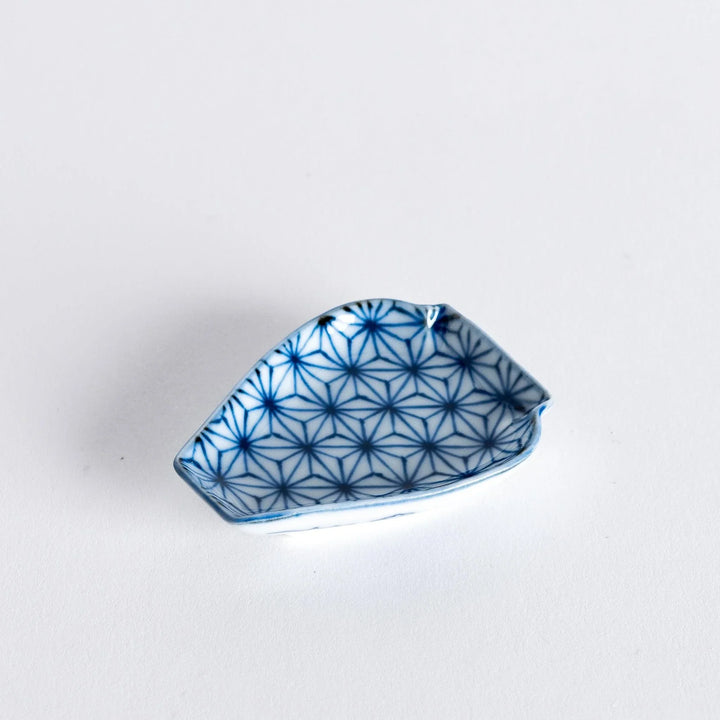 Mini Japanese vase shaped sauce dish with blue geometric flower pattern paired with wooden chopsticks.