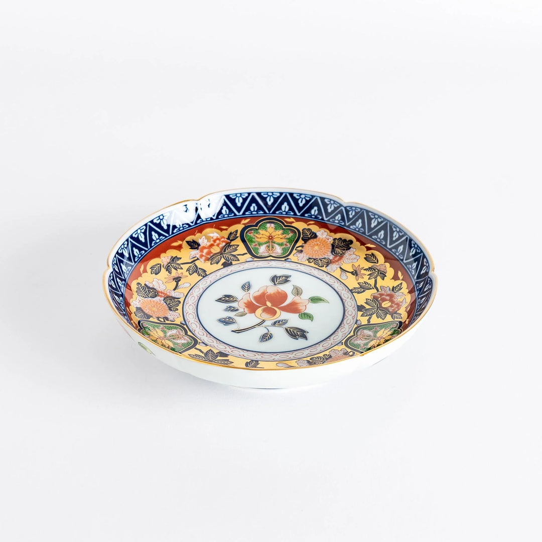 Floral salad plate with gold detailing and red flower center surrounded by green blue and gold patterns.