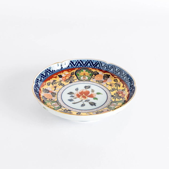 Floral salad plate with gold detailing and red flower center surrounded by green blue and gold patterns.