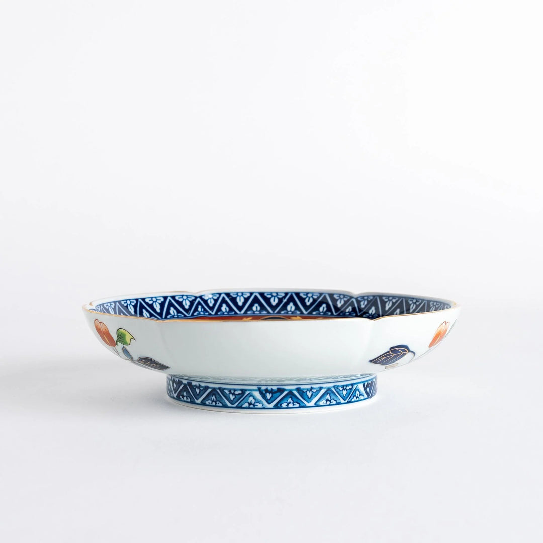 Floral salad plate with gold detailing and red flower center surrounded by green blue and gold patterns.