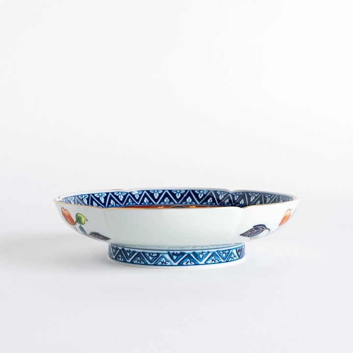 Floral salad plate with gold detailing and red flower center surrounded by green blue and gold patterns.