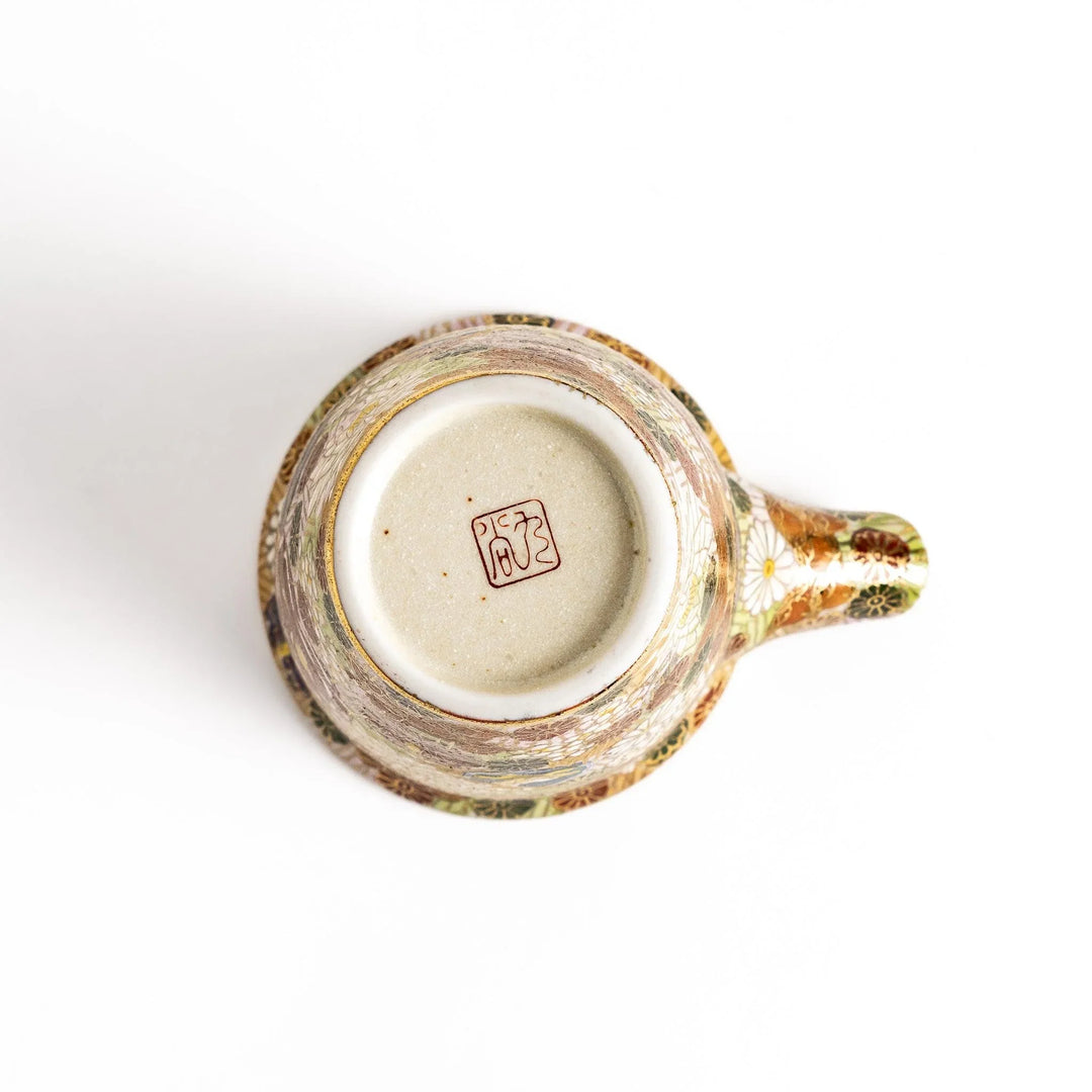 Elegant ceramic sake carafe with gold and pastel floral pattern adding sophistication to sake serving.