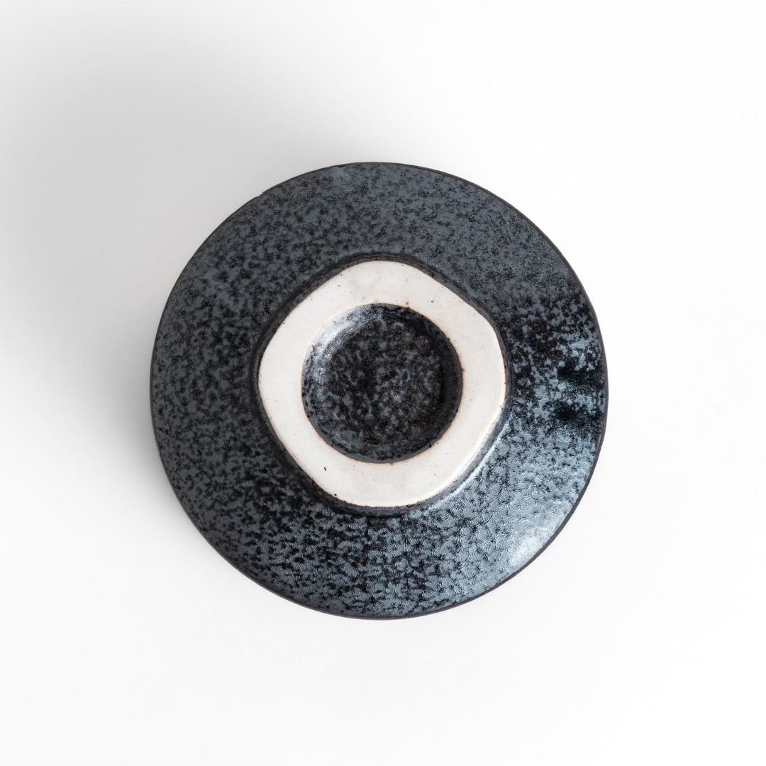 Matcha Bowl featuring a beautiful gold leaf and plum blossom design, set against a dark, textured background.