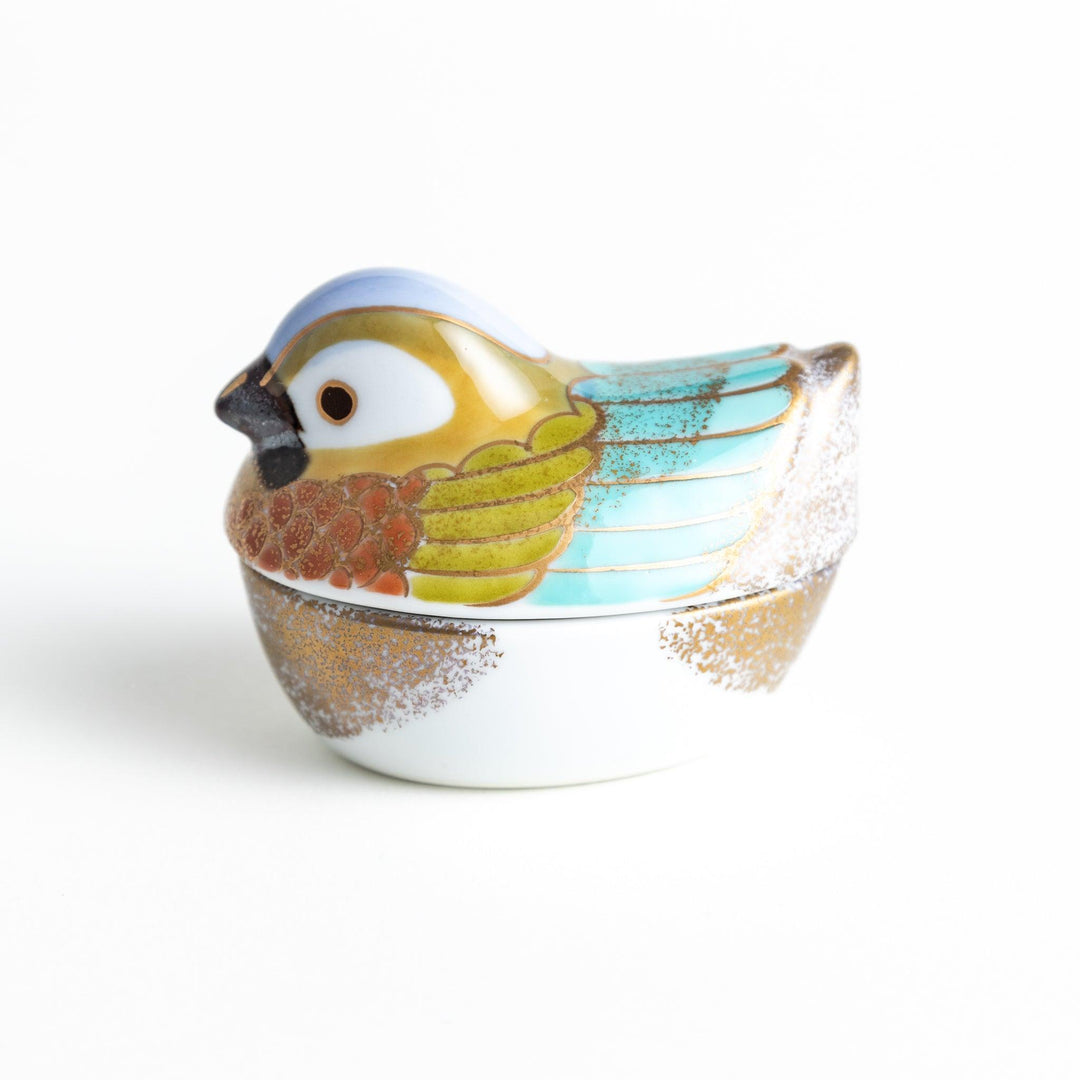 A small condiment bowl shaped like a hen, featuring a detailed painted design with blue, green, and gold accents.