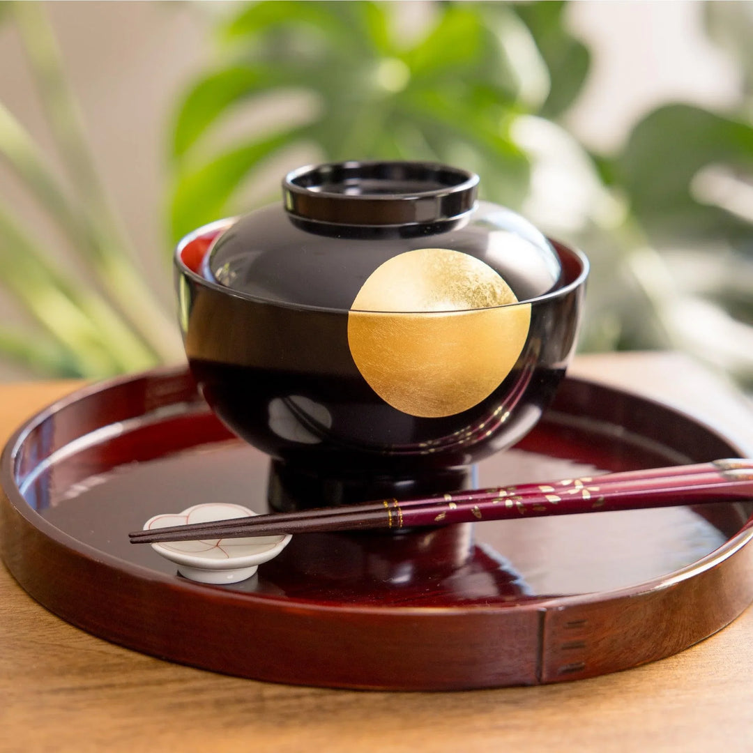 Beautiful black lacquered bowl adorned with a striking gold moon design. Perfect for serving miso soup or other dishes.