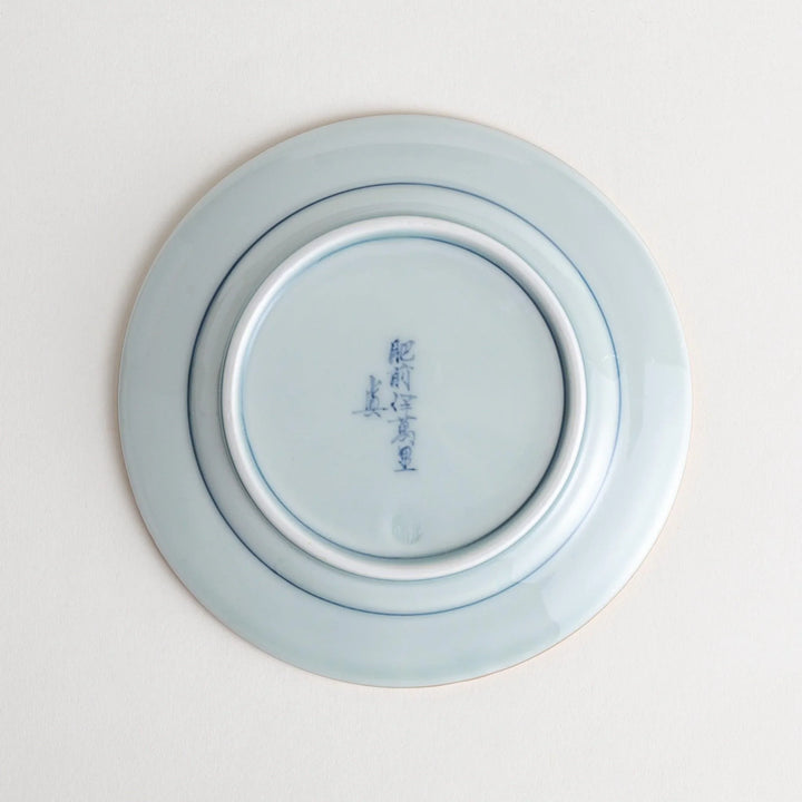 Small Japanese porcelain plate with Imari style floral design and alternating red blue and gold patterns.