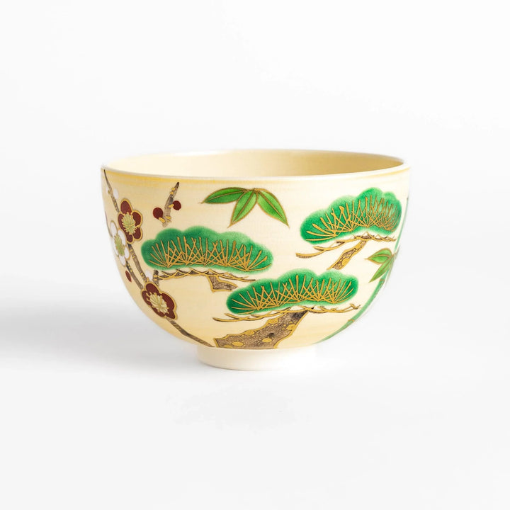 Golden Pine, Bamboo, and Plum Matcha Bowl with green, gold, and red motifs, perfect for an elegant tea experience.