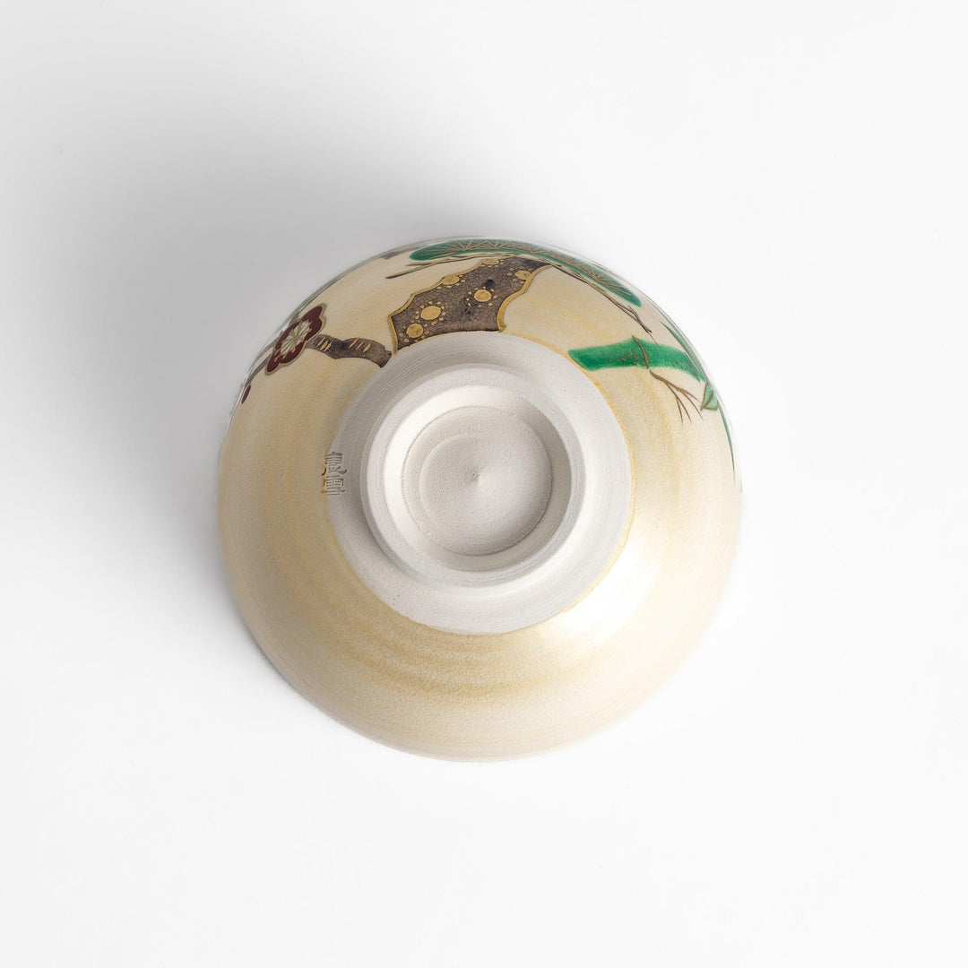 Golden Pine, Bamboo, and Plum Matcha Bowl with green, gold, and red motifs, perfect for an elegant tea experience.