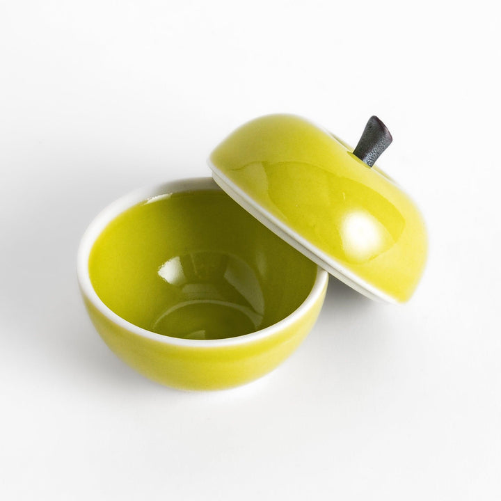 Green apple shaped ceramic condiment bowl with glossy finish and lid perfect for sauces or condiments.