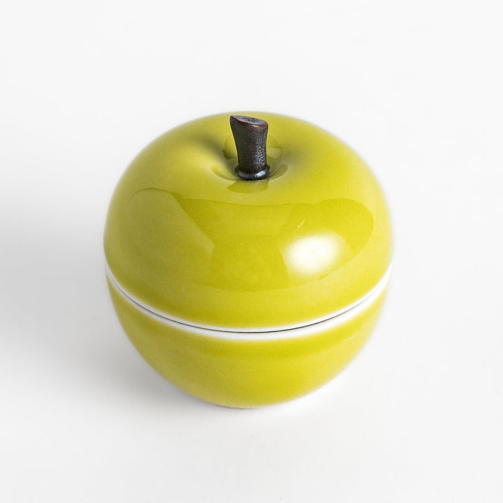 Green apple shaped ceramic condiment bowl with glossy finish and lid perfect for sauces or condiments.