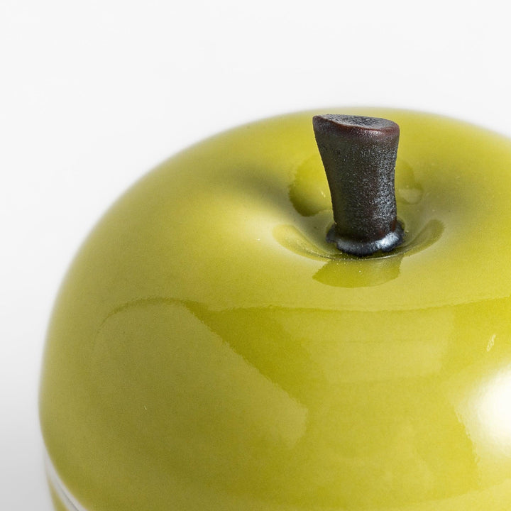 Green apple shaped ceramic condiment bowl with glossy finish and lid perfect for sauces or condiments.
