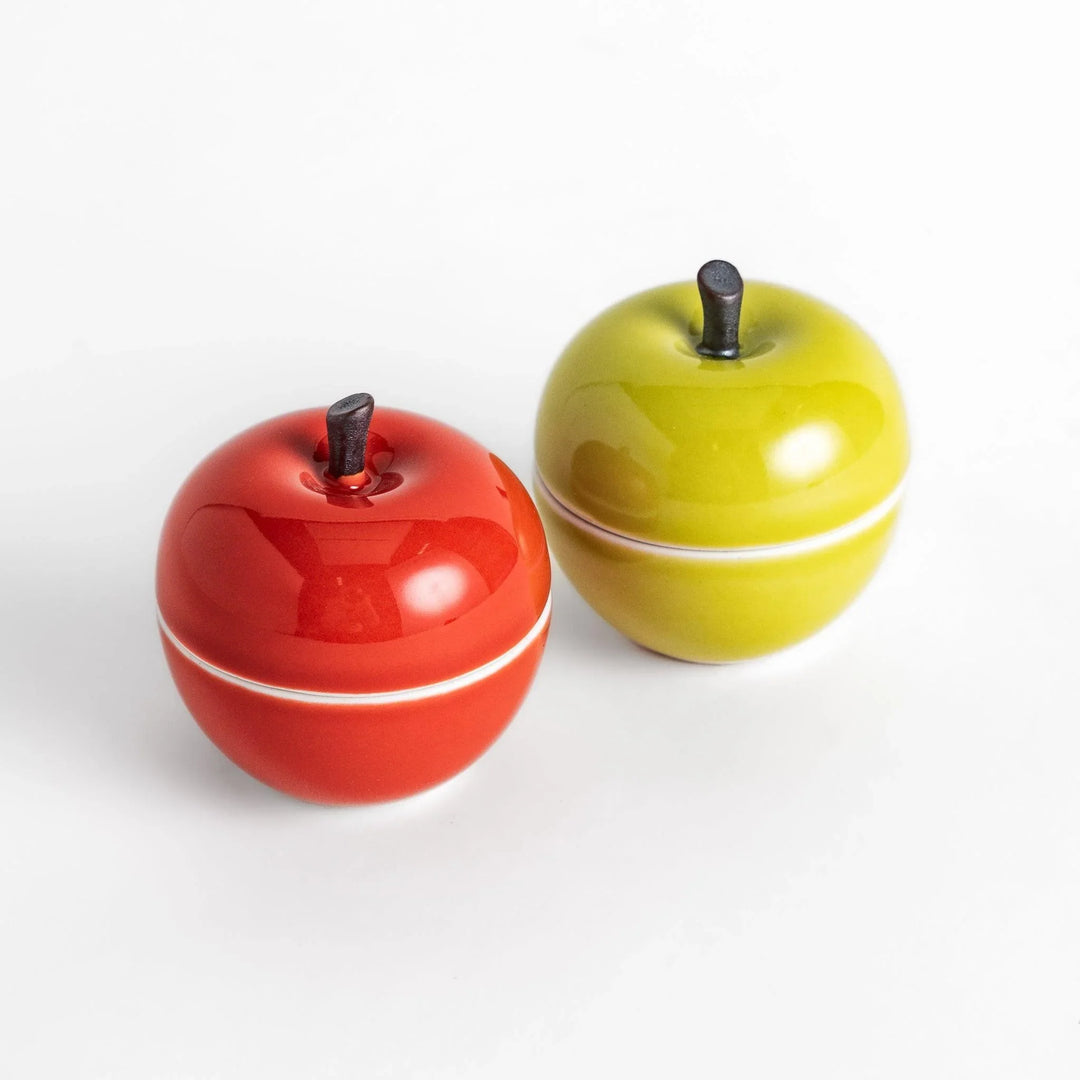 Apple shaped ceramic condiment bowls in red and green glossy finish perfect for sauces or condiments.
